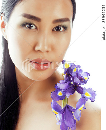 young pretty real asian woman with flower purple orchid isolated on white background spa, healthcare concept young pretty real asian woman with flower purple orchid isolated on white background spa, healthcare concept 83945255