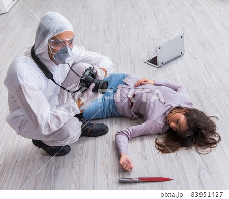 Forensic investigator at the crime scene investigating woman mur Forensic investigator at the crime scene investigating woman mur 83951427