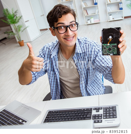 Technician with broken hard drive Technician with broken hard drive 83952815