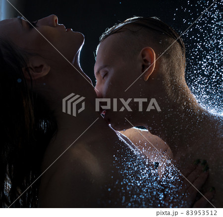 Nude couple embracing in shower in the dark 83953512