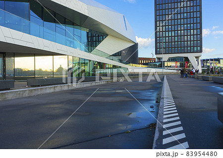 Amsterdam, Netherlands - Nov 30, 2019 : The futuristic building of the Eye Film Museum on the north shore of the harbor named Het IJ in Amsterdam, Netherlands on Nov 30, 2019. Amsterdam, Netherlands - Nov 30, 2019 : The futuristic building of the Eye Film Museum on the north shore of the harbor named Het IJ in Amsterdam, Netherlands on Nov 30, 2019. 83954480