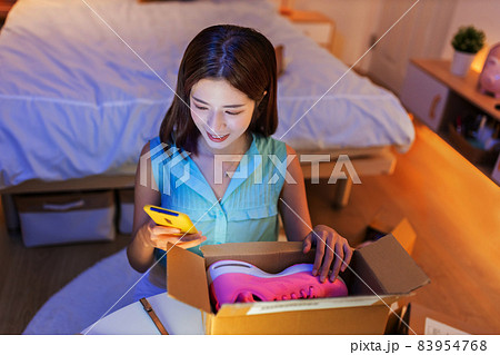 woman open delivery boxes woman open delivery boxes 83954768