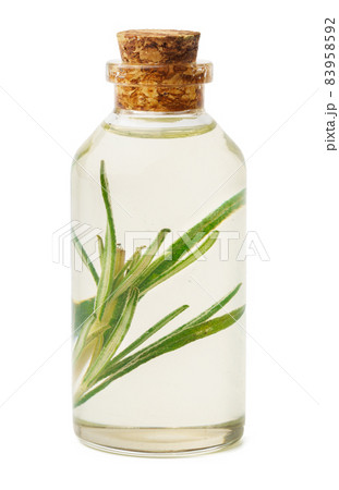 Essential oil in a small bottle with green leaf on white background 83958592