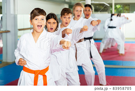 Team of motivated teenagers are engaged in karate in gym Team of motivated teenagers are engaged in karate in gym 83958705