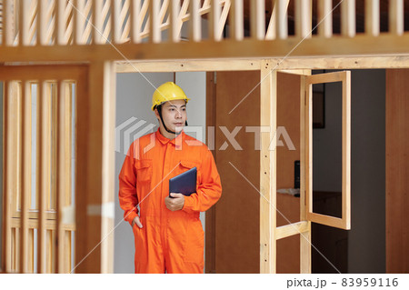 Foreman Walking Around House Under Construction Foreman Walking Around House Under Construction 83959116