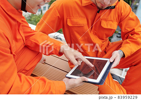 Construction Workers Discussing Blueprint Construction Workers Discussing Blueprint 83959229