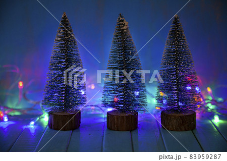 Candle, decor and Christmas tree on the background of Christmas lights. Candle, decor and Christmas tree on the background of Christmas lights. 83959287