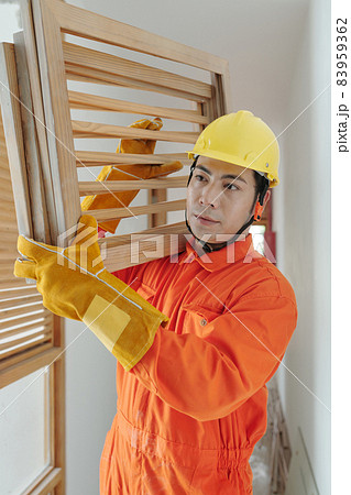 Builder Carrying Wooden Grates 83959362