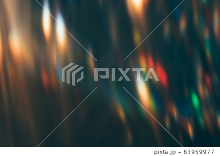 Blur light overlay. Lens flare filter. Defocused sparkles. Festive gleam leak. Bokeh rainbow orange red blue green color rays glow on dark night abstract background. Blur light overlay. Lens flare filter. Defocused sparkles. Festive gleam leak. Bokeh rainbow orange red blue green color rays glow on dark night abstract background. 83959977