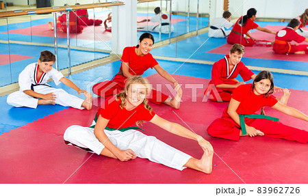 Kids doing warming up before martial arts training 83962726