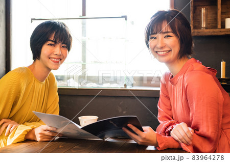 パンフレットを見て旅行フランを練る二人の女性 撮影協力「洋菓子店 sentiment」 パンフレットを見て旅行フランを練る二人の女性 撮影協力「洋菓子店 sentiment」 83964278