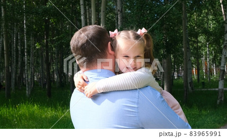 Happy father carrying around his neck and hugging daughter 4-5 years old while walking in the park Happy father carrying around his neck and hugging daughter 4-5 years old while walking in the park 83965991