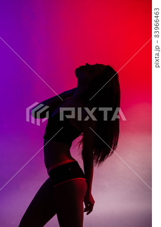 Happy beautiful girl dancing and celebrating standing in full length, isolated on studio background Happy beautiful girl dancing and celebrating standing in full length, isolated on studio background 83966463