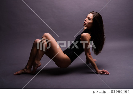 Happy beautiful girl dancing and celebrating standing in full length, isolated on studio background Happy beautiful girl dancing and celebrating standing in full length, isolated on studio background 83966464