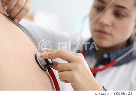 Young female doctor listen to patients back with stethoscope tool 83966522