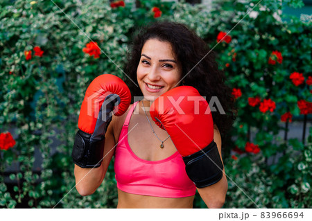 Woman power, self defence concept. Portrait of attractive serious fit boxer, ready for fight Woman power, self defence concept. Portrait of attractive serious fit boxer, ready for fight 83966694