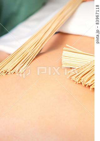 Young woman have double samurai massage with bamboo brooms in spa. Relaxation massage concept. 83967118
