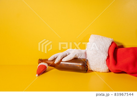 Santa Claus holding beer bottle with his hands Santa Claus holding beer bottle with his hands 83967544