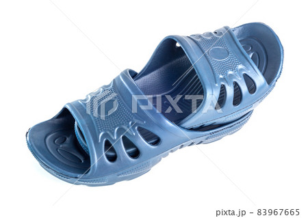 pair of cheap durable blue rubber slippers one inside other isolated on white background. 83967665