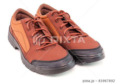 a pair of orange cheap durable fabric travel shoes isolated on white background a pair of orange cheap durable fabric travel shoes isolated on white background 83967892