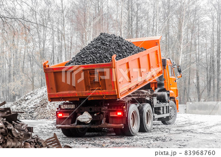 Dump truck in the industrial zone unloads coking coal from the body 83968760