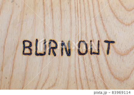 the words burn out handwritten with woodburner on flat plywood surface the words burn out handwritten with woodburner on flat plywood surface 83969114