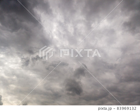 grey broad storm clouds background, upward view grey broad storm clouds background, upward view 83969132