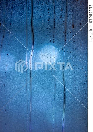 an abstract background of night wet window glass with smudges in blue tone gamma an abstract background of night wet window glass with smudges in blue tone gamma 83969557