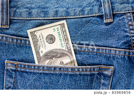 a hundred dollar banknote sticking out from rear jeans pocket a hundred dollar banknote sticking out from rear jeans pocket 83969856