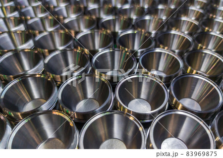 A batch of shiny steel parts. Regular industrial metal production pattern with selective focus. 83969875