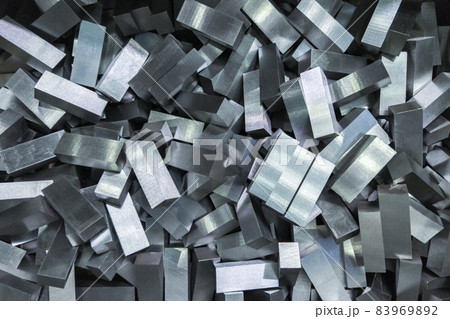 a pile of shiny faceted steel blocks - full frame close-up with selective focus 83969892
