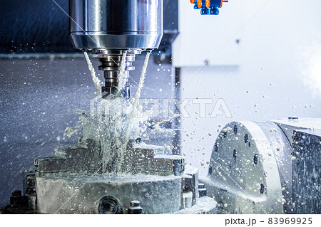a process of industrial wet milling in 5-axis cnc machine with coolant flow under pressure and freezed splashes 83969925