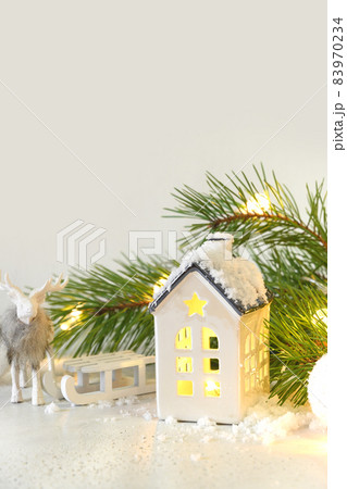 Christmas fairy tale with a magical snow-covered house, a deer and a sleigh. Christmas fairy tale with a magical snow-covered house, a deer and a sleigh. 83970234
