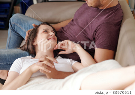 Woman Resting Head on Laps of Boyfriend Woman Resting Head on Laps of Boyfriend 83970611