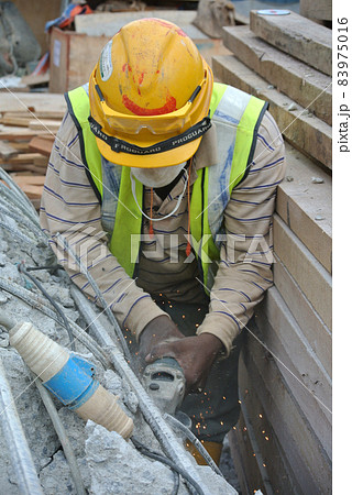 SELANGOR, MALAYSIA -MARCH 15, 2015: Construction workers cutting metal using mobile grinder at the construction site in Selangor, Malaysia.  83975016
