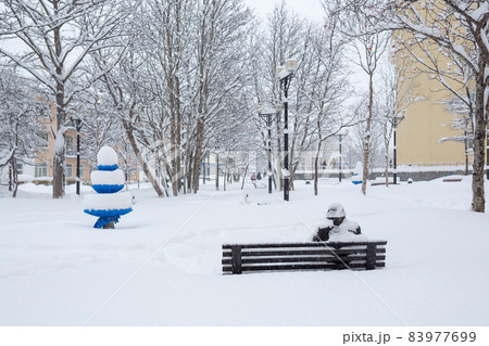 Bench in a snowy city square. Magadan, Far East of Russia. 83977699