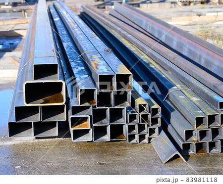 A pack of rectangular metal pipe outdoors. High quality photo 83981118