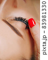 Eyelash Extension Procedure. Woman Eye with Long Eyelashes. Close up, selective focus. 83981330