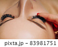Eyelash Extension Procedure. Woman Eye with Long Eyelashes. Close up, selective focus. 83981751