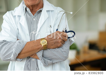 Cropped image of a professional middle-aged male doctor with his arms crossed. Cropped image of a professional middle-aged male doctor with his arms crossed. 83982800