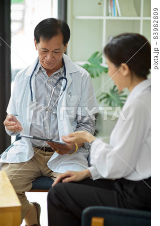 Middle-aged male specialist doctor examine diagnosis female patient. Middle-aged male specialist doctor examine diagnosis female patient. 83982809