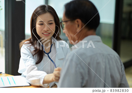 Doctor examining middle aged male patient in hospital office. Doctor examining middle aged male patient in hospital office. 83982830
