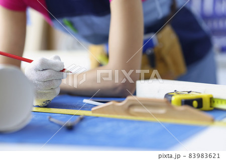 Woman worker making corrections in construction planning with pencil 83983621