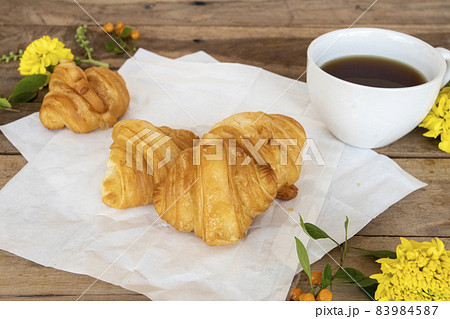 croissant dessert snack on paper with hot tea arrangement flat lay postcard style croissant dessert snack on paper with hot tea arrangement flat lay postcard style 83984587