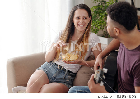 Laughing Woman Eating Potato Chips Laughing Woman Eating Potato Chips 83984908