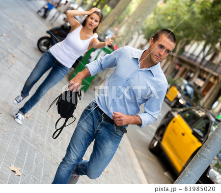 Bandit man running with handbag after stole this from emotional female Bandit man running with handbag after stole this from emotional female 83985020