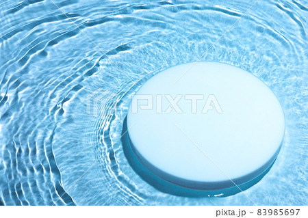Empty white circle podium on transparent blue water background with copy space Empty white circle podium on transparent blue water background with copy space 83985697