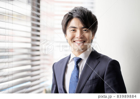 窓辺に立つアジア人のビジネスマン 83989884