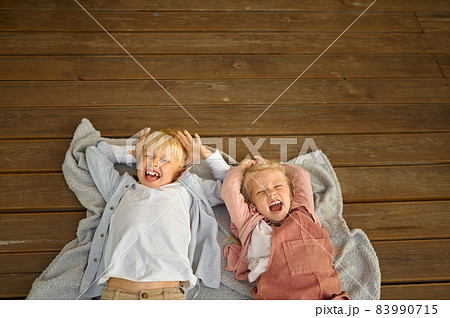 Funny children lying on terrace floor in trailer 83990715