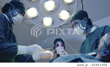 Medical surgical doctor team performing surgery patient 83991468